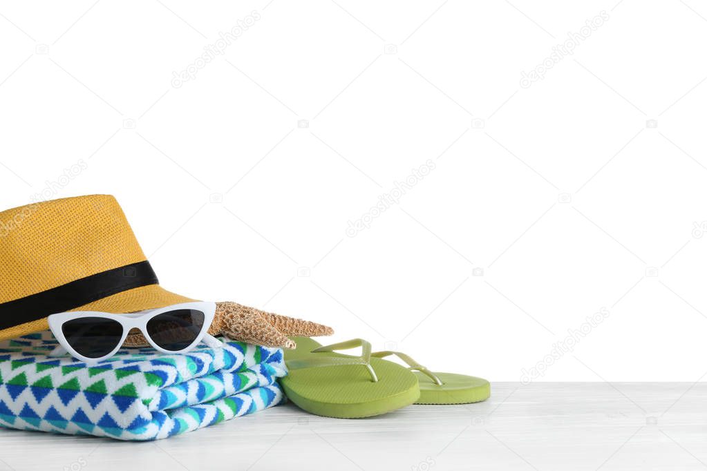 Set of beach accessories on table against white background. Space for text