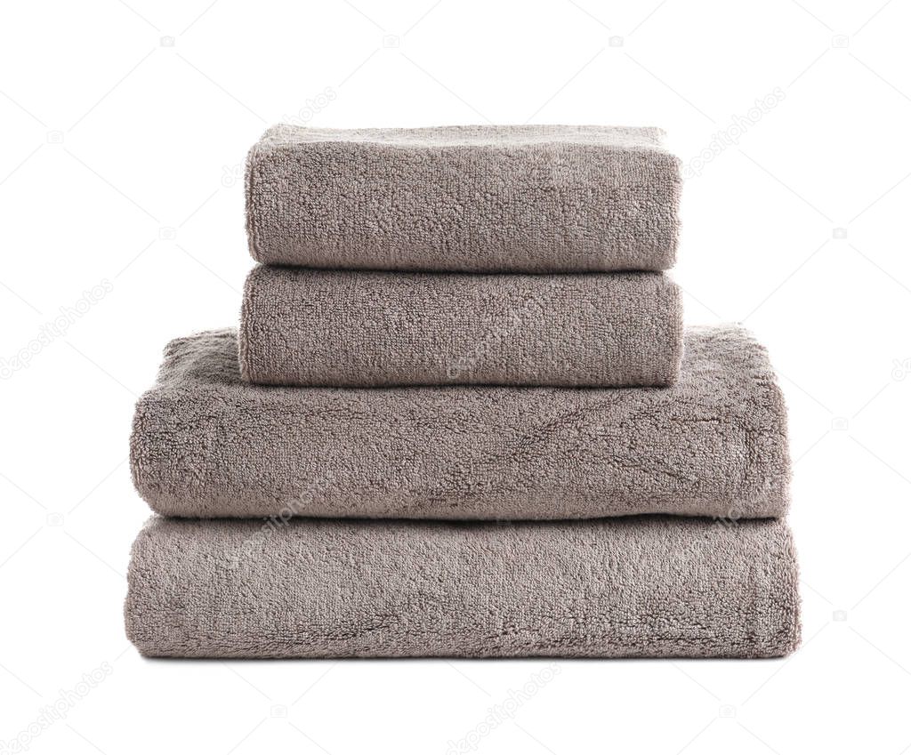 Stack of fresh towels isolated on white