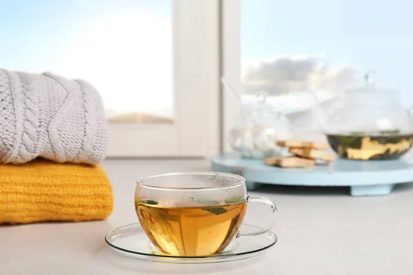 Composition with cup of hot winter drink on windowsill — Stock Photo, Image