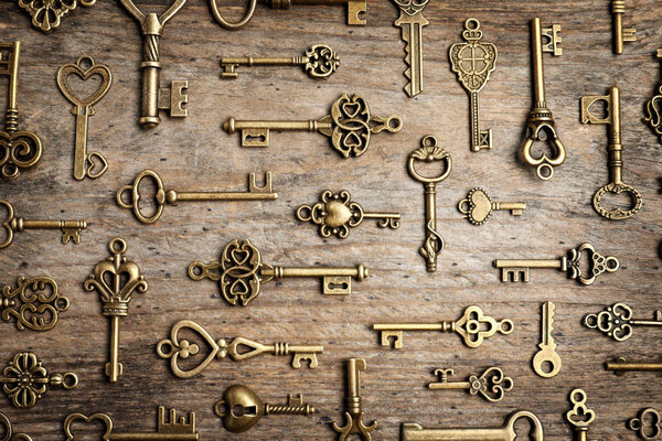 Плоская композиция с старинными ключами на деревянном фоне
