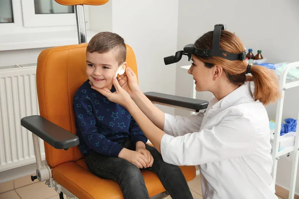 Профессиональный отоларинголог осматривает маленького мальчика в клинике. Расстройство слуха — стоковое фото