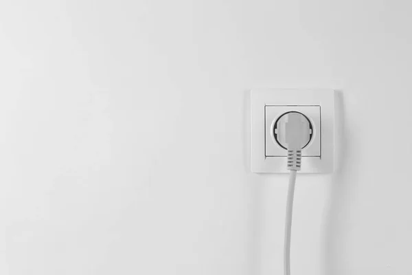 Power socket and plug on white background. Electrician\'s equipment