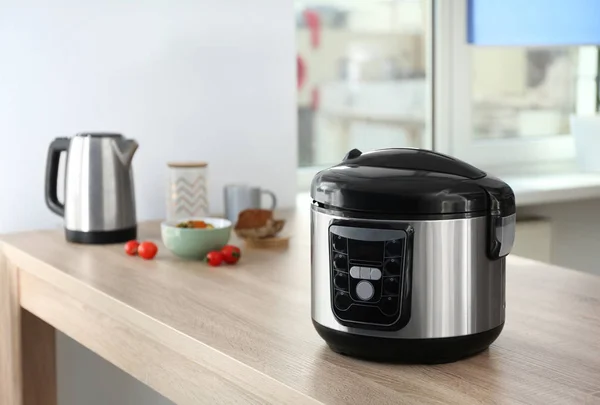 Modern multi cooker and ingredients on table in kitchen — Stock Photo, Image