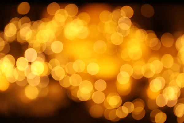 Gold glitter with bokeh effect on dark background — Stock Photo, Image