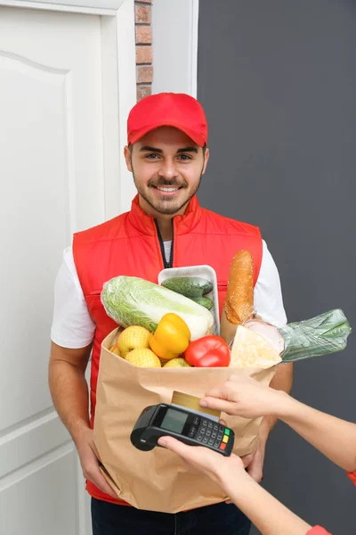 Woman using terminal to pay for food delivery indoors — Stock Photo, Image