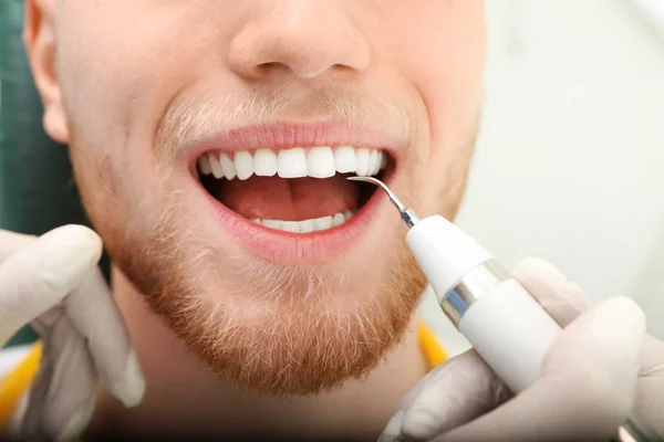 Professional dentist working with patient in modern clinic, closeup. Teeth care — Stock Photo, Image