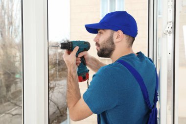 Süre installing pencere kapalı matkap kullanarak inşaat işçisi