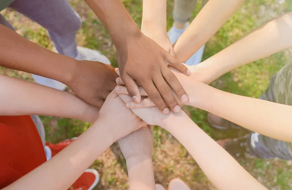 Crianças juntando as mãos ao ar livre, close-up. Conceito de ajuda — Fotografia de Stock