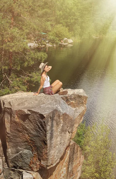 Young woman on rocky mountain near lake. Zen, balance, harmony — Stock Photo, Image