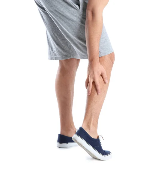 Hombre que sufre de dolor en las piernas sobre fondo blanco, primer plano —  Fotos de Stock