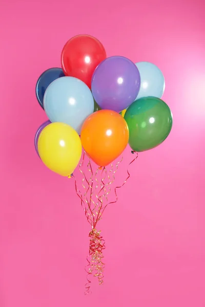 Bunch of bright balloons on color background — Stock Photo, Image