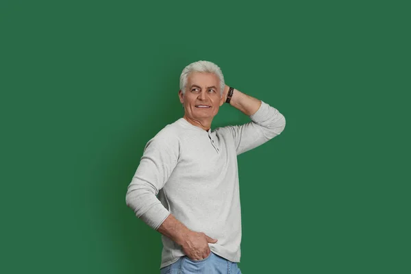 Portrait of handsome mature man on color background — Stock Photo, Image