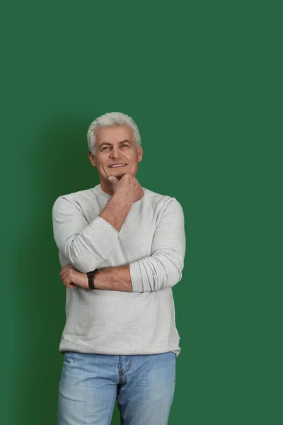 Portrait of handsome mature man on color background — Stock Photo, Image
