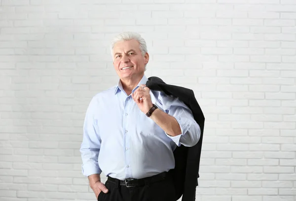 Portrait d'un bel homme mature près d'un mur de briques — Photo