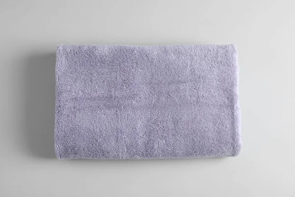 Fresh fluffy towel on grey background, top view. Mockup for design — Stock Photo, Image