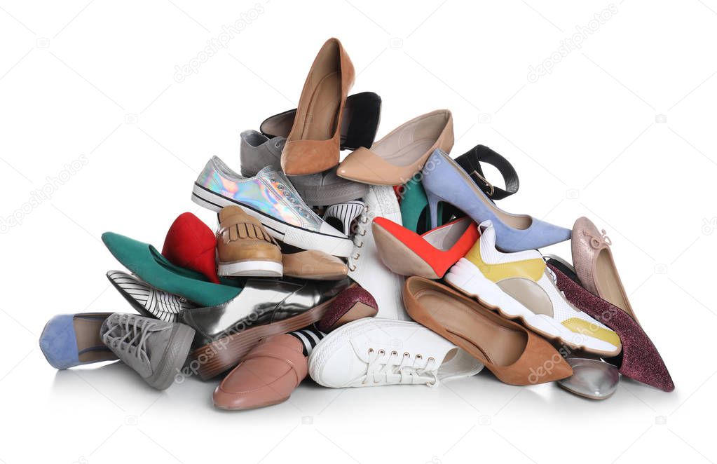 Pile of female shoes on white background