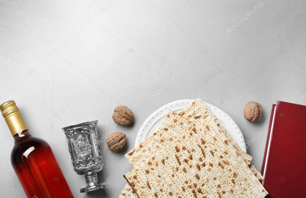 Flat lay composition with symbolic Passover (Pesach) items on light background, space for text