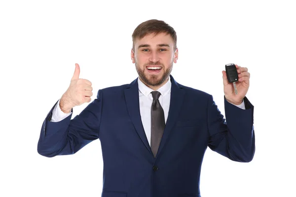 Glad ung affärsman med bilnyckel på vit bakgrund — Stockfoto
