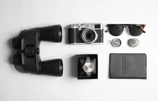 Flat lay composition with camera and binoculars on white background. Travel agency — Stock Photo, Image