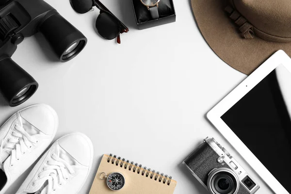 Flat lay composition with tablet, binoculars and camera on white background, space for text. Travel agency — Stock Photo, Image