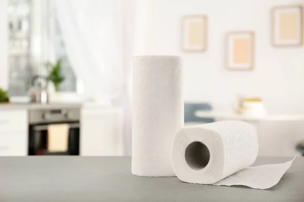 Rolls of paper towels on table in kitchen — Stock Photo, Image