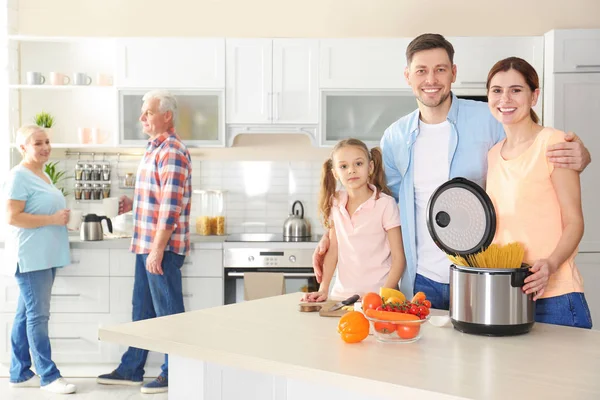 Happy family with modern multi cooker in kitchen — Stock Photo, Image