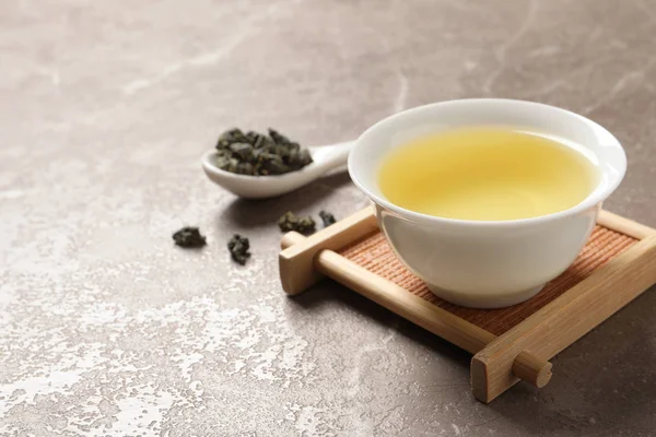 Cup of Tie Guan Yin oolong tea on table. Space for text Stock Photo