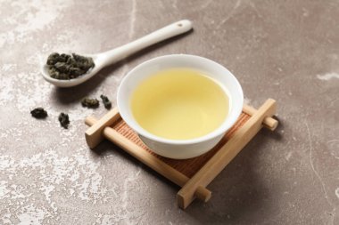 Kravat Guan Yin oolong çay kaşığı fincan masada bırakır