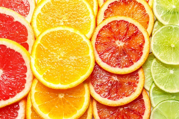Plátky čerstvých citrusových plodů jako pozadí, pohled shora — Stock fotografie
