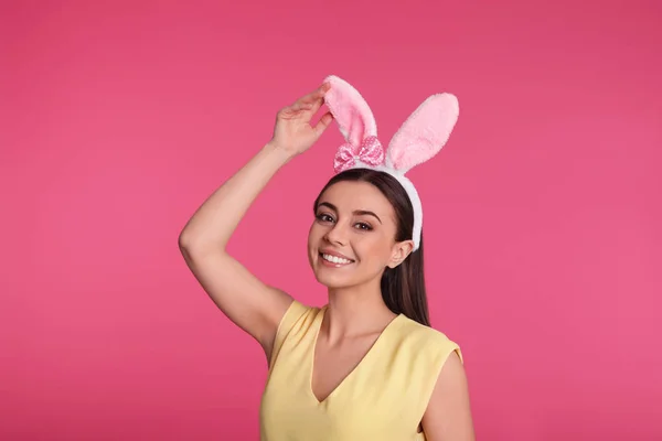 Portrait of beautiful woman in Easter bunny ears headband on color background — Stock Photo, Image