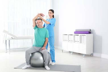 Doktor hastanede hasta ile çalışma. Rehabilitasyon egzersizleri
