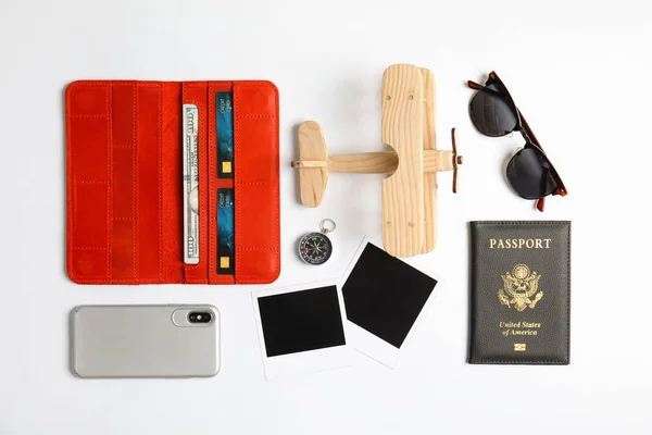 Flat lay composition with toy airplane and passport on white background. Travel agency — Stock Photo, Image