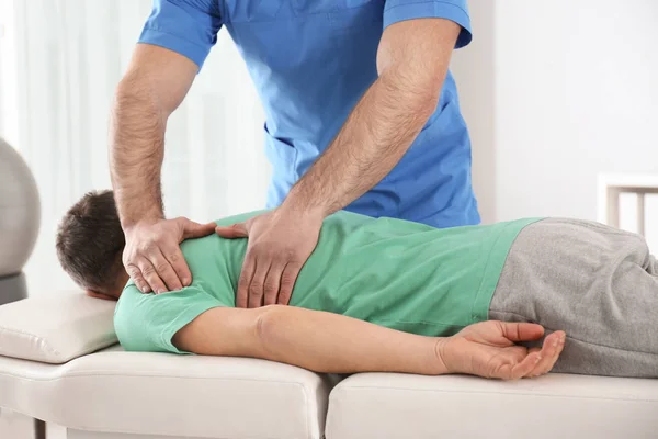 Arts werkzaam met patiënt in het ziekenhuis. Revalidatie massage — Stockfoto