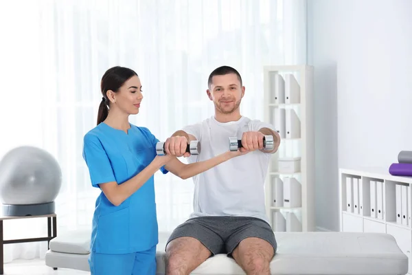 Doctor working with patient in hospital. Rehabilitation exercises — Stock Photo, Image