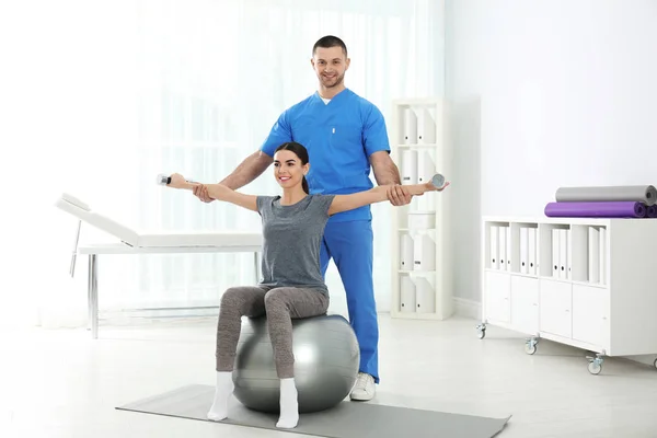 Doctor working with patient in hospital. Rehabilitation exercises — Stock Photo, Image