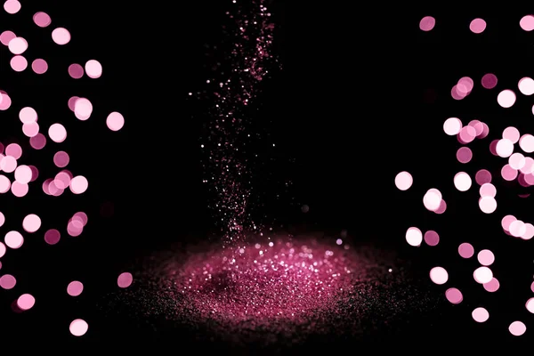 Ψέκασμα ροζ glitter σε μαύρο φόντο, bokeh αποτέλεσμα — Φωτογραφία Αρχείου