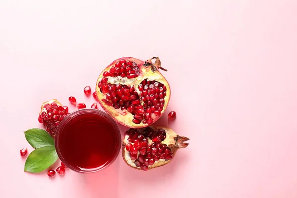 Glass of pomegranate juice and fresh fruits on color background, top view with space for text — Stock Photo, Image