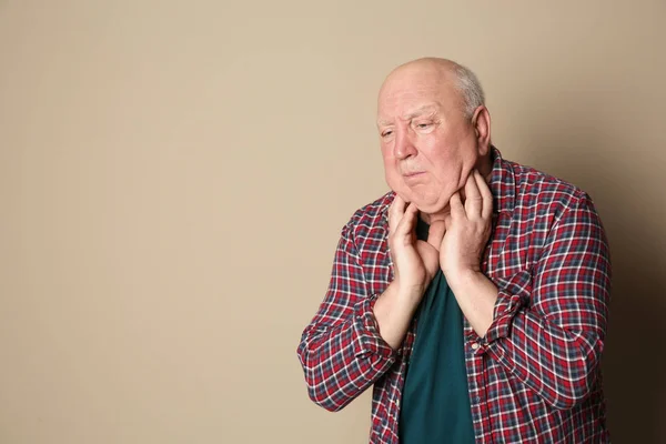 Senior férfi szenved a köhögés, a háttér színét. Hely a szöveg — Stock Fotó