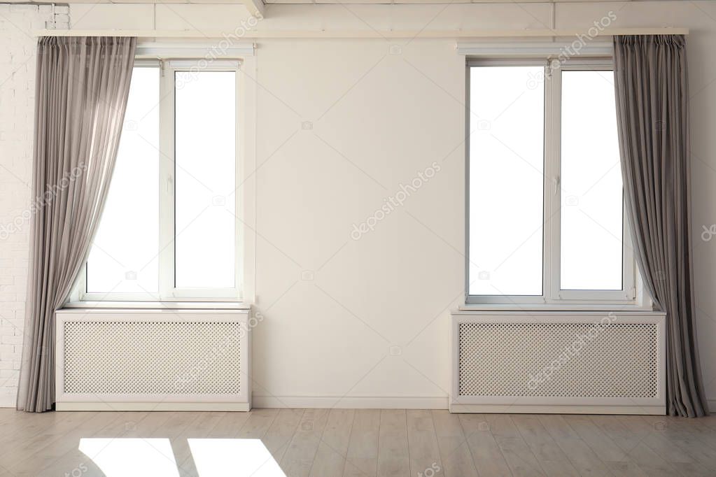 New modern windows with curtains in room