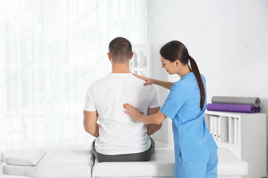 Doctor working with patient in hospital. Rehabilitation massage