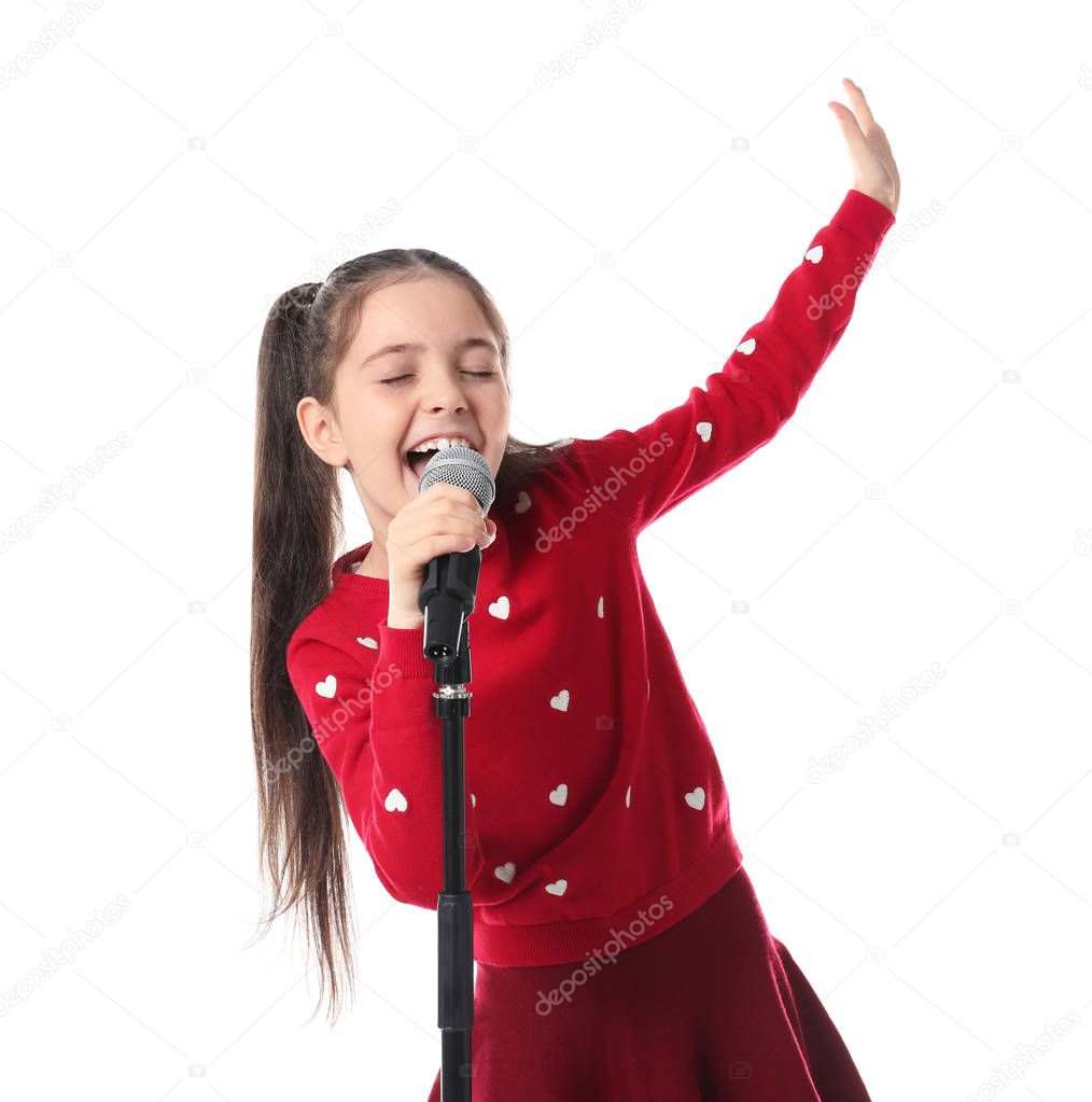 Little girl singing into microphone on white background