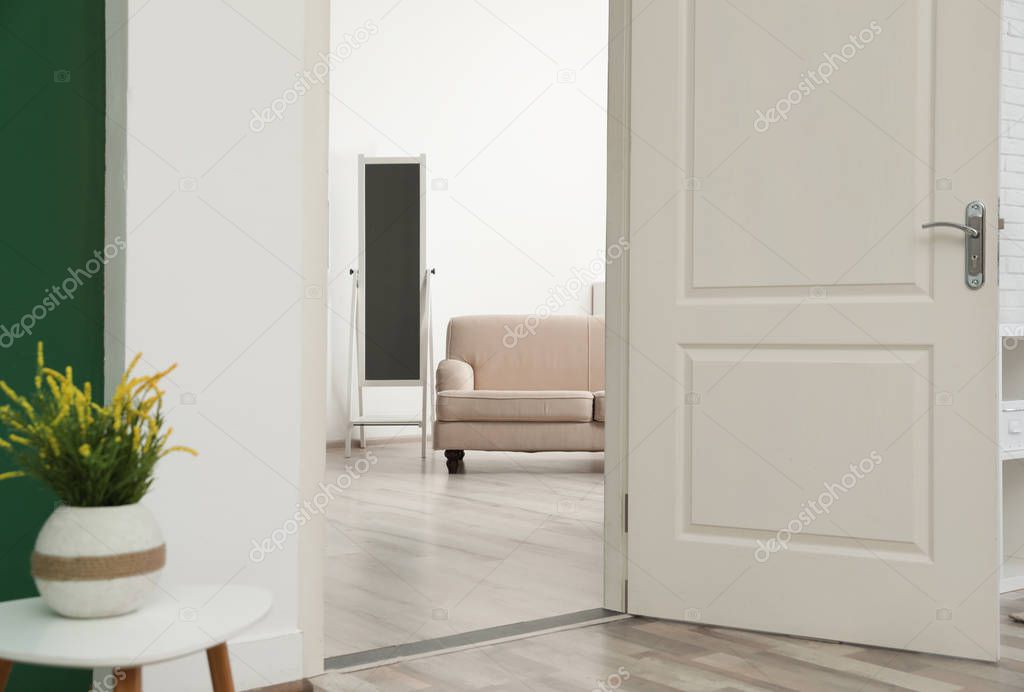 Stylish room interior, view through open door