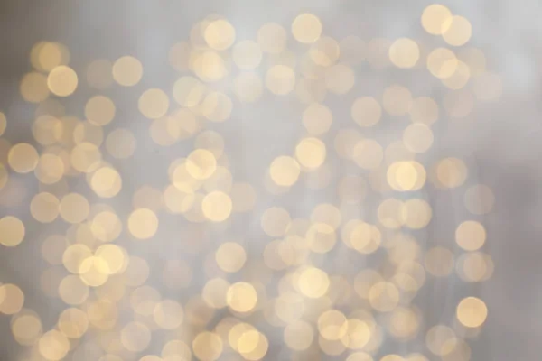 Vista borrosa de las luces doradas de Navidad como fondo. Efecto Bokeh — Foto de Stock