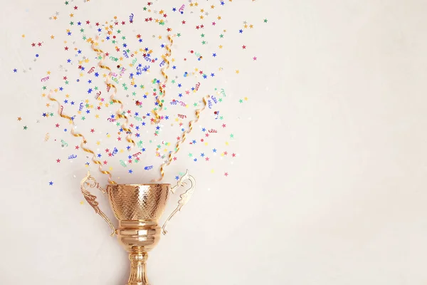 Trophy and confetti on light background, top view with space for text. Victory concept — Stock Photo, Image