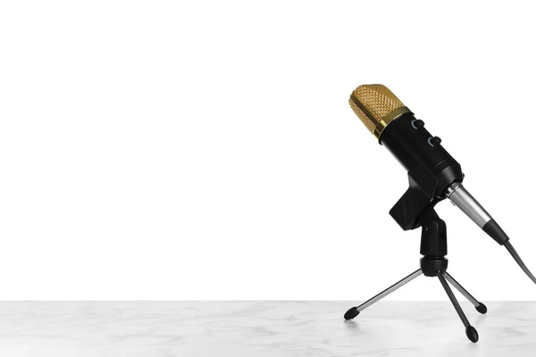 Microphone on table against white background. Space for text — Stock Photo, Image