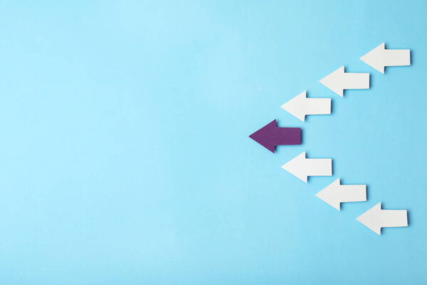 White arrows following after different one on color background, top view with space for text. Victory concept