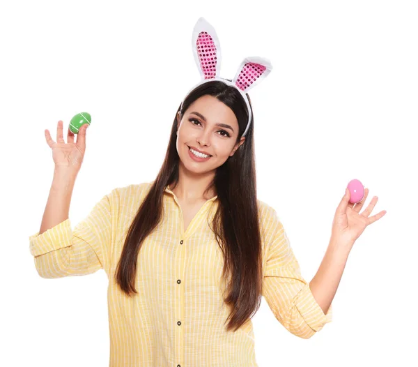 Beautiful woman in bunny ears headband holding Easter eggs on white background — Stock Photo, Image