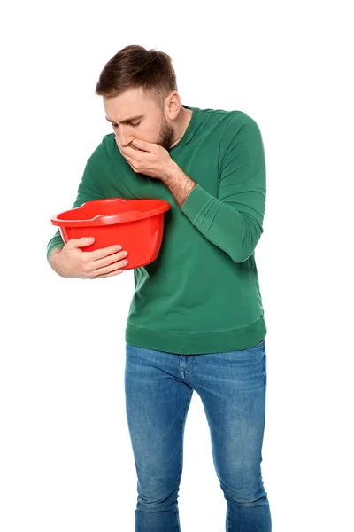 Young man with basin suffering from nausea isolated on white — Stock Photo, Image