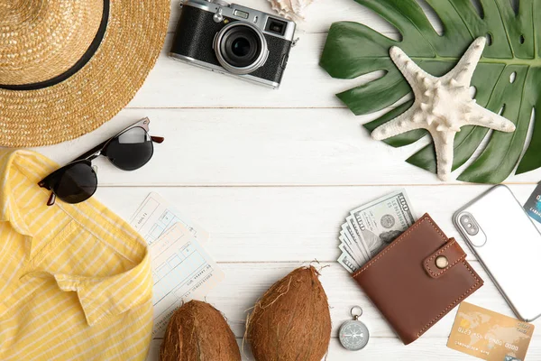 Flat lay composition with tourist items for beach vacation on wooden background, space for text. Travel agency — Stock Photo, Image
