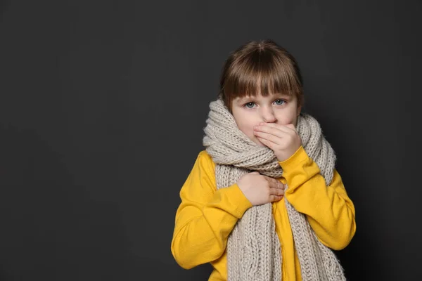 Cute little girl coughing against dark background. Space for text — Stock Photo, Image